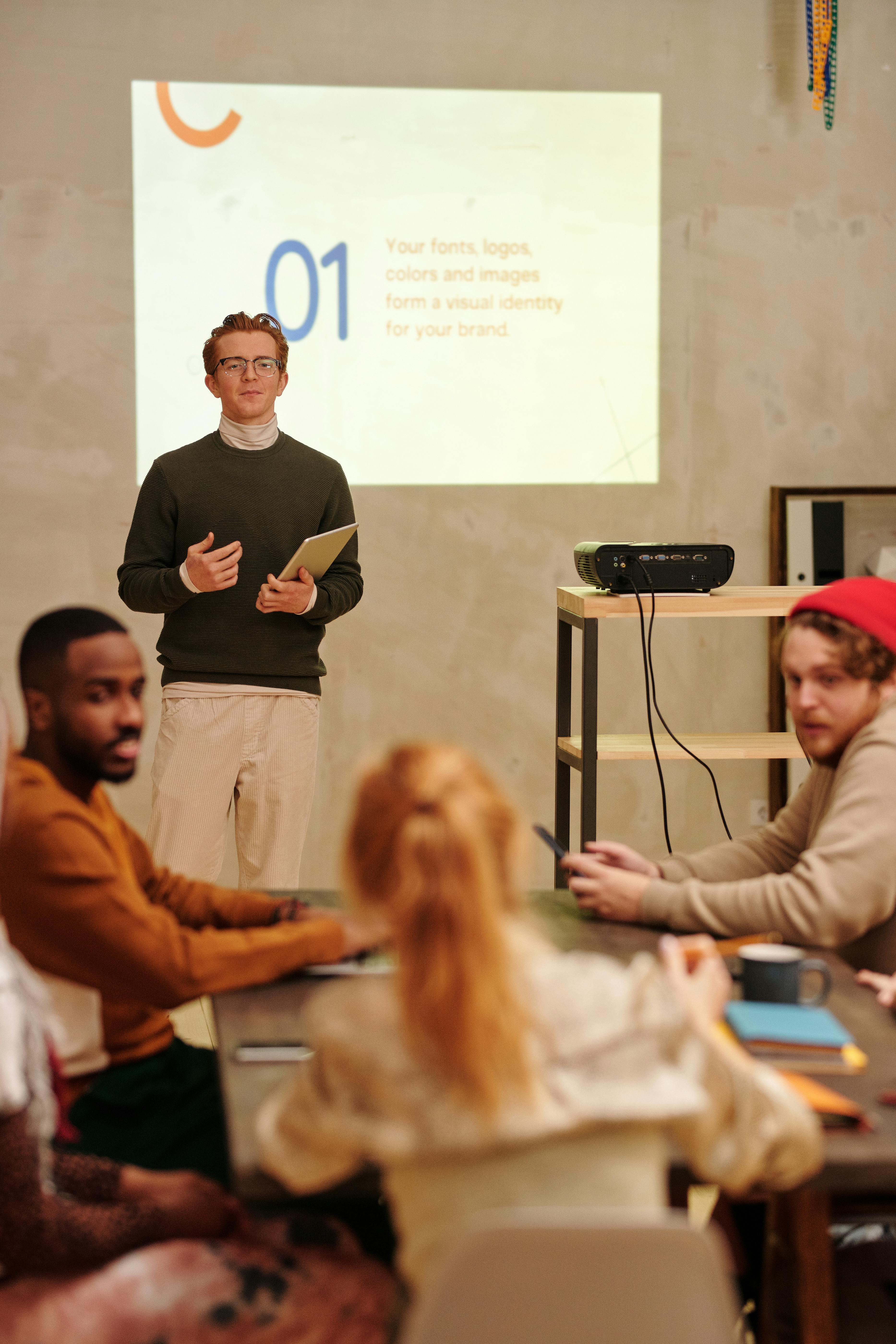 A person presenting in front of a group of three people
